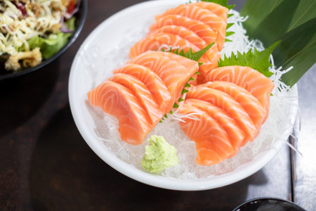 Fresh sliced salmon or salmon sashimi with in white bowl set on table, Japanese food.の写真素材