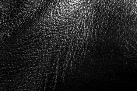 bright natural real black leather with Flexes dark waves background texture abstract close up, luxury black cow leather texture backgroundの写真素材