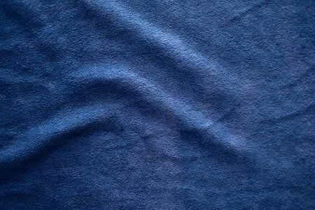 Blurred of dark blue silk satin. Soft folds. Fabric. blue luxury background. Space for design. Wavy lines. Banner. Flat lay, top view table. Beautiful. Elegant. Birthday, Christmas, Valentine's Day.の写真素材
