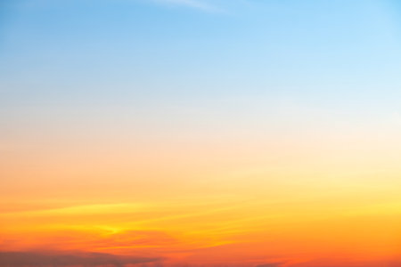 Beautiful of luxury soft gradient orange gold clouds and sunlight on the blue sky perfect for the background, take in everning,Twilightの写真素材