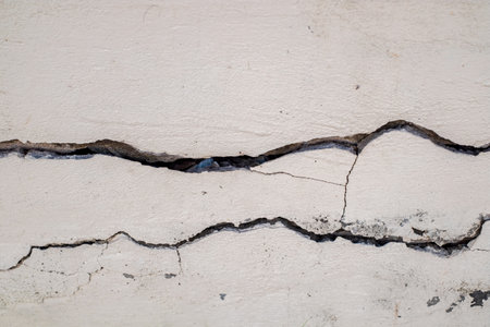 Cracked concrete wall broken wall at the outside cement corner that effected with earthquake and collapsed groundの写真素材