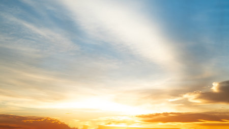 Beautiful , luxury soft gradient orange gold clouds and sunlight on the blue sky perfect for the background, take in everning,Twilight, Large size, high definition landscape photoの写真素材