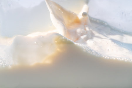 Milk water liquid white color drink and food texture background, Beautiful natural caw milk wave and bubble splash texture with macro on top view, Healthy food dailyの写真素材