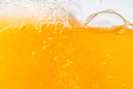Close up bright orange Oil or beer splash texture and nature waves, Beautiful waves curve and little...