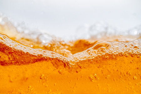 Close up bright orange Oil splash texture and nature waves, Beautiful waves curve and little bubbles smooth for graphic design and background, Oil Bubbles, Soft bubbles, Selective focusの写真素材