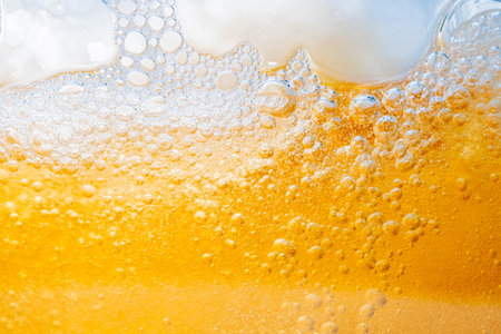 Close up bright orange Oil or beer splash texture and nature waves, Beautiful waves curve and little...