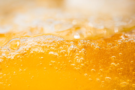 Close up bright orange splash texture and nature waves, Beautiful waves curve and little bubbles smooth for graphic design and background, Bubbles, Soft bubbles, Selective focusの写真素材