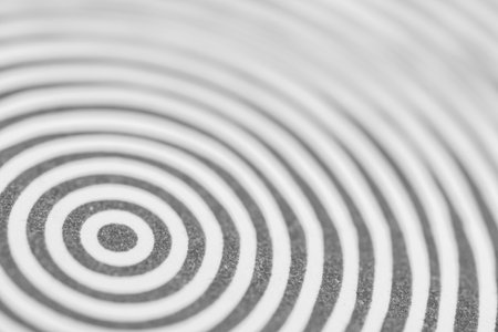 Abstract black and white concentric circles creating a hypnotic pattern. Ideal for backgrounds, concepts of focus, repetition, optical illusions, or design themesの写真素材