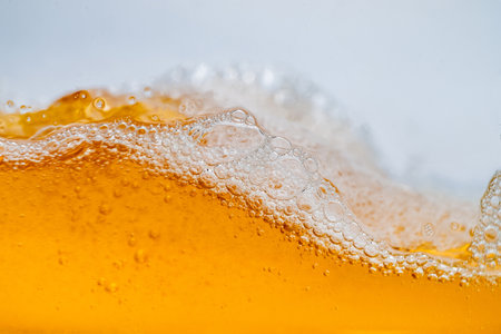 Close up bright orange Oil or splash texture and nature waves, Beautiful waves curve and little bubbles smooth for graphic design and background, Oil Bubbles, Selective focusの写真素材