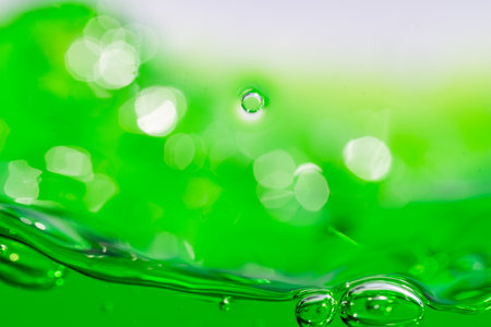 Water wave, close up of vibrant green liquid with bubbles, capturing dynamic movement and freshness....