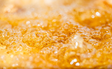 Close up bright orange Oil splash texture and nature waves, Beautiful waves curve and little bubbles smooth for graphic design and background, Oil Bubbles, Selective focusの写真素材