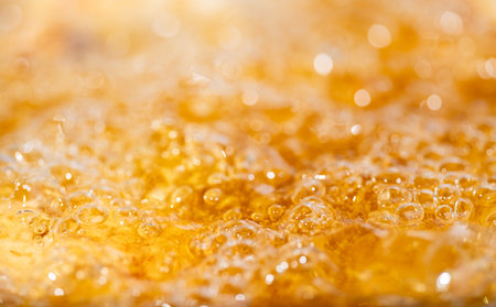 Close up bright orange Oil splash texture and nature waves, Beautiful waves curve and little bubbles smooth for graphic design and background, Oil Bubbles, Selective focusの写真素材