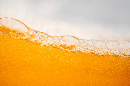 Close up bright orange liquid splash texture and nature waves, Beautiful waves curve and little...