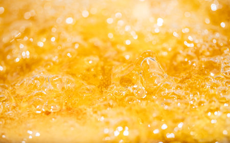 Close up bright orange Oil or beer splash texture and nature waves, Beautiful waves curve and little...