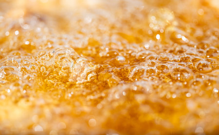Close up bright orange Oil or beer splash texture and nature waves, Beautiful waves curve and little bubbles smooth for graphic design and background, Oil Bubbles, Selective focusの写真素材