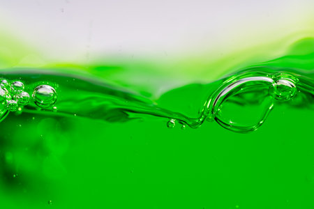 Water wave, close up of vibrant green liquid with bubbles, capturing dynamic movement and freshness. Perfect for backgrounds, beverages, or abstract concepts. soft drinkの写真素材