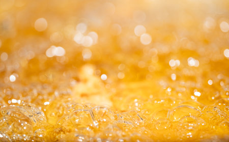 Close up bright orange Oil or beer splash texture and nature waves, Beautiful waves curve and little bubbles smooth for graphic design and background, Oil Bubbles, Soft beer bubbles, Selective focusの写真素材