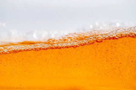 Close up bright orange Oil or beer splash texture and nature waves, Beautiful waves curve and little...