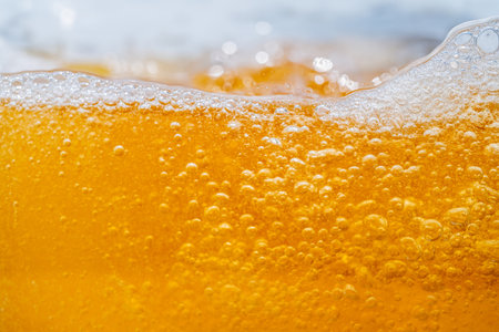 Close up bright orange Oil or beer splash texture and nature waves, Beautiful waves curve and little...