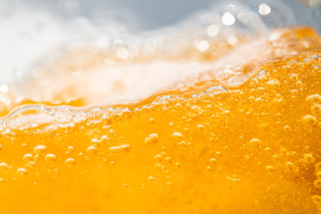 Close up bright orange Oil or beer splash texture and nature waves, Beautiful waves curve and little...