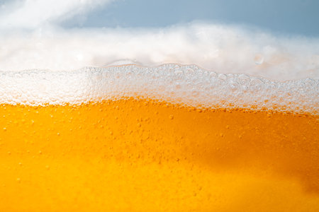 Close up bright orange Oil or beer splash texture and nature waves, Beautiful waves curve and little...