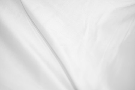 Abstract White Bedding Sheets or White wrinkled fabric background texture and Texture with copy-space :Creased or wrinkled white fabric,Soft focusの写真素材