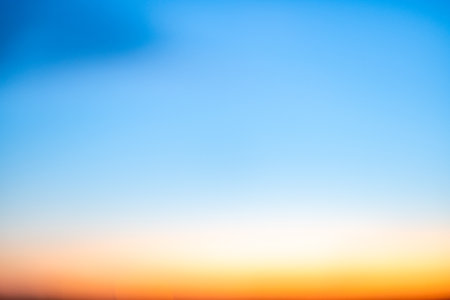 Beautiful , luxury soft gradient orange gold blur clouds and sunlight on the blue sky perfect for the background, take in evening,Twilight, Large size, high definition landscape photoの写真素材