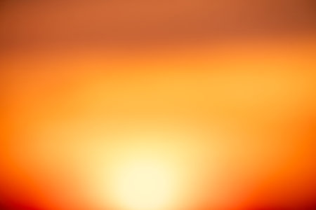 Beautiful soft gradient orange gold clouds and sunlight on the blue sky perfect for the background,...