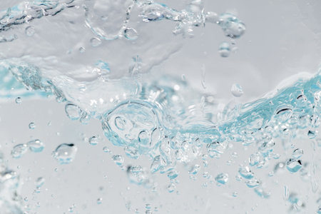 Closeup Transparent blue clear water surface texture with ripples. Abstractâ ofâ surfaceâ blueâ splashes and bubblesâ water waves  reflectedâ withâ sunlightâの写真素材