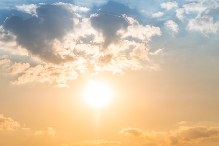 Sunset or sunrise sky with a vibrant gradient of orange, gold, and soft blue. Clear atmosphere with wispy clouds. Peaceful, natural light background. hope, freedom, new day and inspirational Conceptsの写真素材