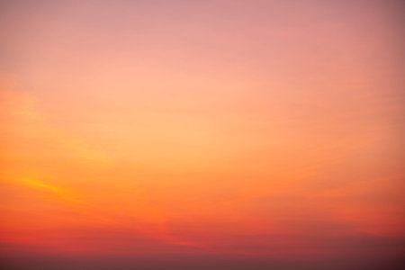 Beautiful sunrise sky with vibrant gradient orange and gold colors and soft blue, Clear atmosphere...