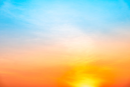 Beautiful sunrise sky with vibrant gradient orange and gold colors and soft blue, Clear atmosphere...