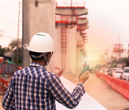 the engineer controlling the electric train is using radio to communicate with foreman in the construction projectの写真素材