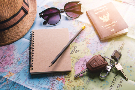 Travel planner using world map and pencil book to note Thailand passport, car keyの写真素材