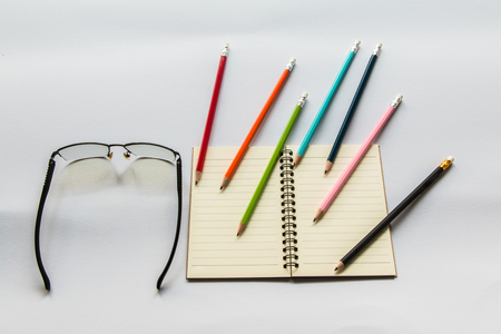 Book Pencils Glasses On white background.の写真素材