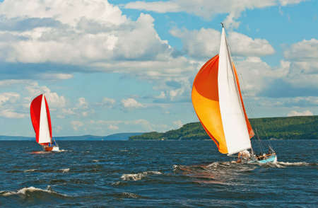 The yacht is participating in a regatta in gloomy weather