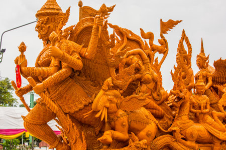 Thai style candle wax carving in traditional candle procession festival, Thailand.の写真素材