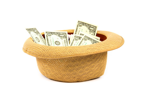 Hat with money inside it isolated on white background の写真素材