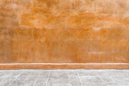 Old orange wall with floor corridor.の写真素材