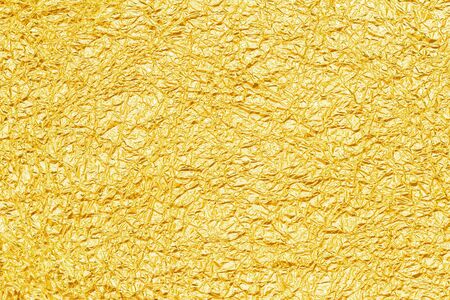 Shiny yellow gold foil abstract texture backgroundの写真素材