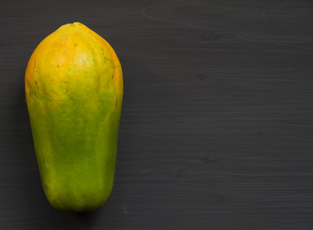 Papaya on wooden black backgroundの写真素材