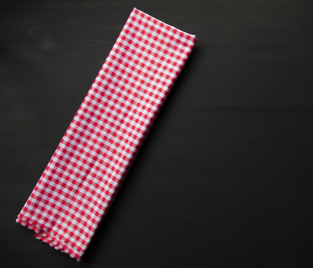 Checkered napkin on wooden background