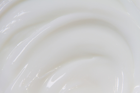 The white surface of the cream lotion softens the background.の写真素材