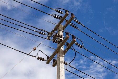 Equipment for electric wires on electricity poles on a clear sky.