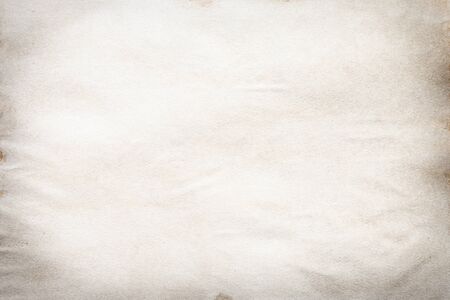 Old brown and white paper stained with coffee. Vintage abstract background.の写真素材