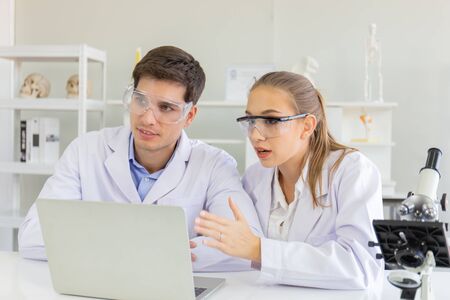 The concept of health care researchers, researchers working in biological science laboratories, young research scientists and male supervisorsの写真素材