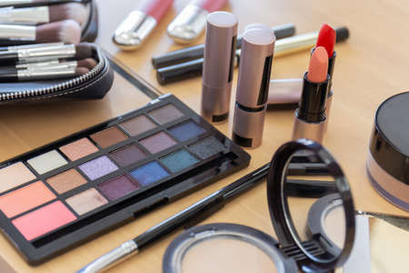 Many make-up cosmetics on the wooden tableの写真素材
