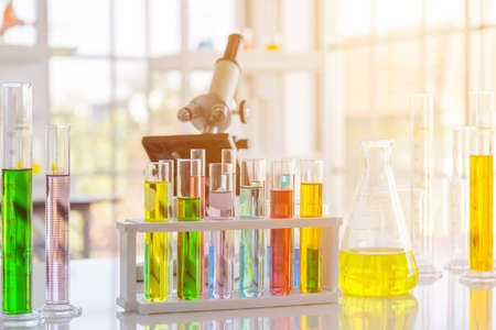 Chemical reagent in scientific experiment flasks of various shapes, sizes and with orange light.の写真素材