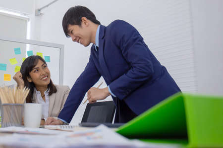 Asian business women and men are sitting in the officeの写真素材