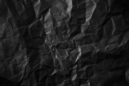 Textured crumpled black paper background.の写真素材
